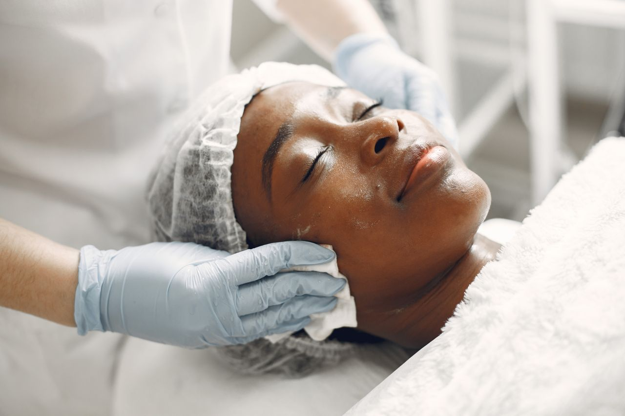 A woman receiving a gentle facial treatment during a spa session for skincare and relaxation.
